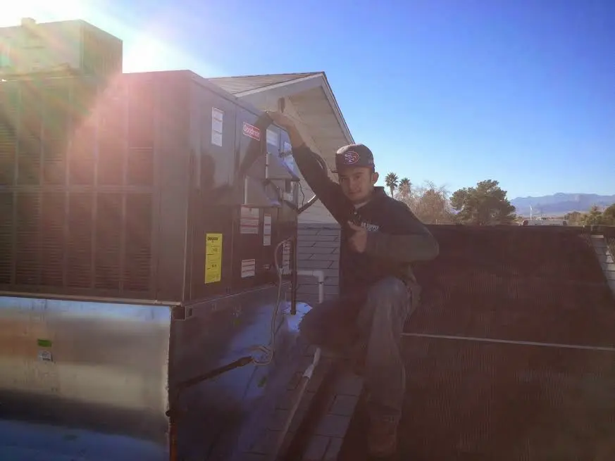 HVAC technician performing AC Tune-Up on a rooftop unit in Hacienda Heights
